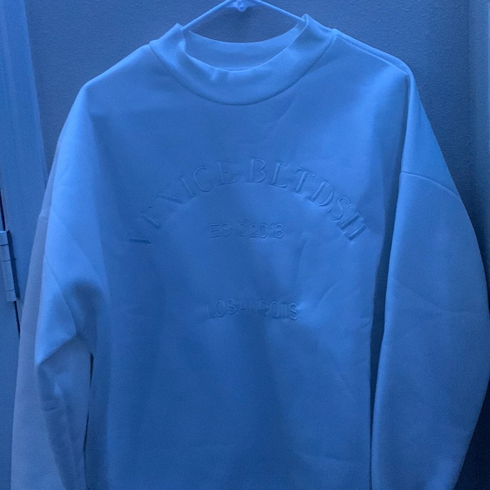 White crew neck sweater.